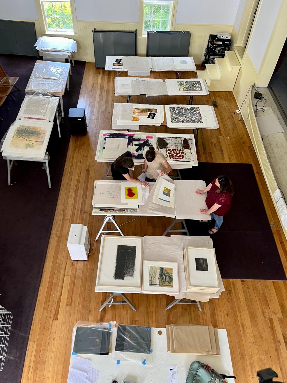 Carolyn Frisa, Candace Truso (Vermont Studio Center Grants Manager), and Patty Hudak (printmaker and volunteer coordinator) discuss treatment plans for Vermont Studio Center's decades old print collection-- a quarter of which was damaged during the floods.