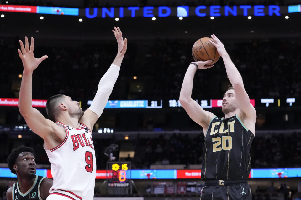 Charlotte Hornets' Gordon Hayward shoots as Chicago Bulls' Nikola Vucevic defends during the first half of an NBA basketball game, Thursday, Feb. 2, 2023, in Chicago. (AP Photo/Charles Rex Arbogast)