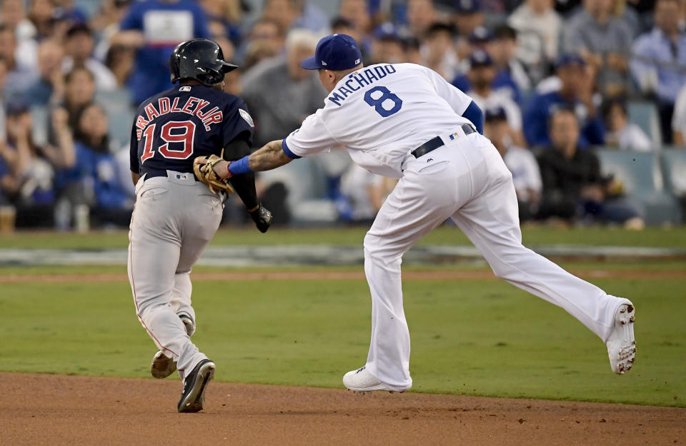 Los Angeles Dodgers shortstop Manny Machado, right, tags Boston Red Sox's Jackie Bradley Jr. in a run down during the third inning in Game 3 of the World Series baseball game on Friday, Oct. 26, 2018, in Los Angeles. (AP Photo/Mark J. Terrill)