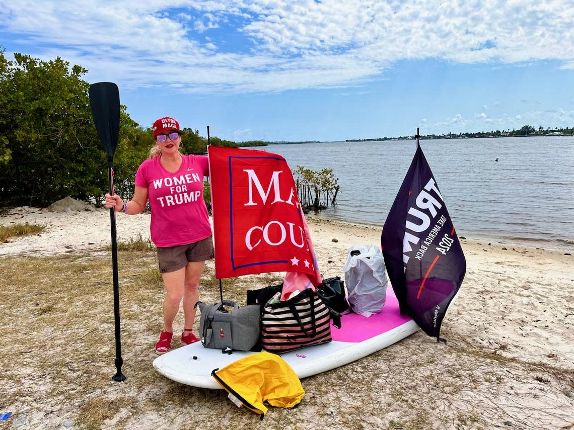 Trump supporter Maria Korynsel, of North Palm Beach, prepares to launch her paddleboard on the Intracoastal behind Mar-a-Lago on the afternoon of April 4 to show her support for former President Donald Trump, who was in a New York court room pleading not guilty to charges brought by the Manhattan District Attorney.