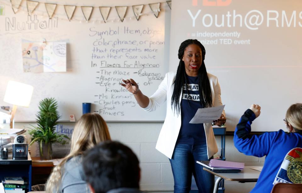 Jamesia Nordman, an English professor at Grand Valley State University and an educator at Marshall Public Schools in Marshall, talks with eighth grade students in the classroom of Roberta Nuttall on Thursday, March 21, 2024.