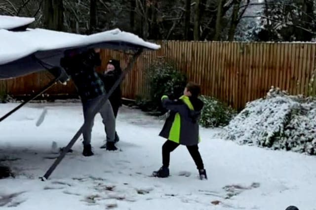 Watch the moment a dad tried shower his kids in snow from the top of a gazebo, but the prank backfires when it collapses on top of him!