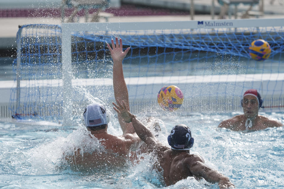 U.S. Olympic Water Polo Team attacker Max Irving, foreground middle, trains for the Paris Olympics, at Mt. San Antonio College in Walnut, Calif., on Wednesday, Jan. 17, 2024. Irving's father, Michael Irving, is a Pac-12 college basketball referee. Max Irving is also the only Black man on the U.S. Olympic Water Polo Team and a prominent advocate for diversity in the sport. (AP Photo/Damian Dovarganes)