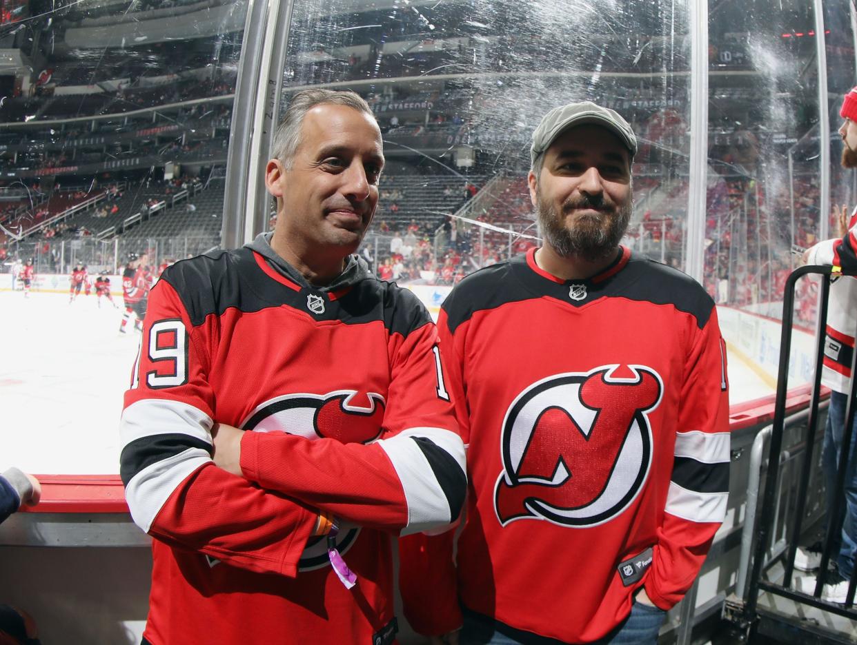 FILE - Joe Gatto and Brian "Q" Quinn gets ready to be hit by several pucks during a hockey game between the New Jersey Devils and the Calgary Flames on an episode of "Impractical Jokers" in 2019. Gatto will perform standup comedy in Augusta on Sept. 28.