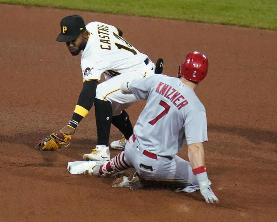 St. Louis Cardinals' Andrew Knizner (7) slides into second with a leadoff double as Pittsburgh Pirates shortstop Rodolfo Castro (14) applies a late tag during the seventh inning of a baseball game Tuesday, Oct. 4, 2022, in Pittsburgh. (AP Photo/Keith Srakocic)