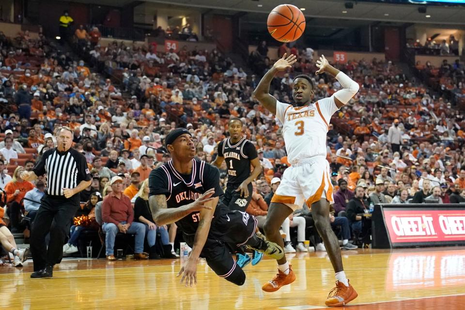 OSU guard Avery Anderson (0) passes the ball while defended by Texas guard Courtney Ramey (3) during the second half at Frank C. Erwin Jr. Center on Saturday.