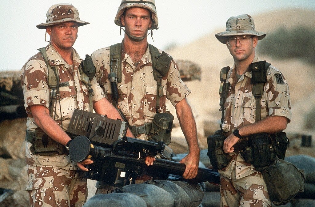 Members of Btry. A, 5162nd Air Defense Arty. Regt., 11th Air Defense Arty. Bde., hold an FIM-92A Stinger portable missile launcher as they pose for a photograph during Operation Desert Shield. (USAF PHOTO BY SSGT F. LEE CORKRAN DA-ST-92-06695)