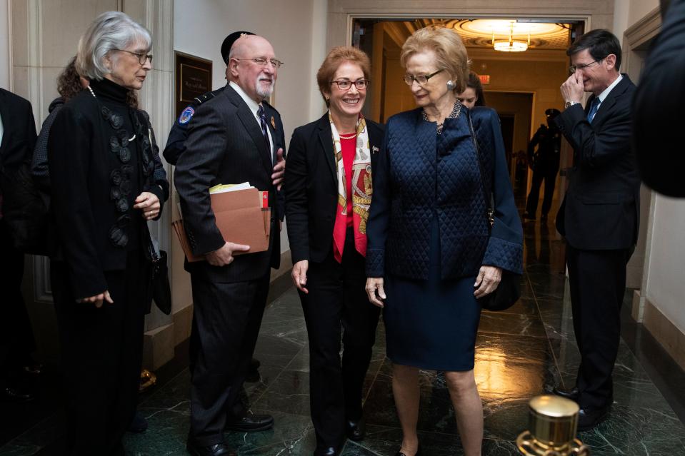 Former U.S. Ambassador to Ukraine Marie Yovanovitch, center, leaves the hearing room for a break during the second public impeachment hearing of President Donald Trump's efforts to tie U.S. aid for Ukraine to investigations of his political opponents on Nov. 15, 2019, on Capitol Hill in Washington.