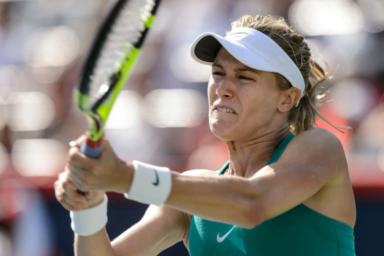 Eugenie Bouchard of Canada hits a return against Lucie Safarova of Czech Republic during day two of the Rogers Cup at Uniprix Stadium on in Montreal, Quebec, Canada