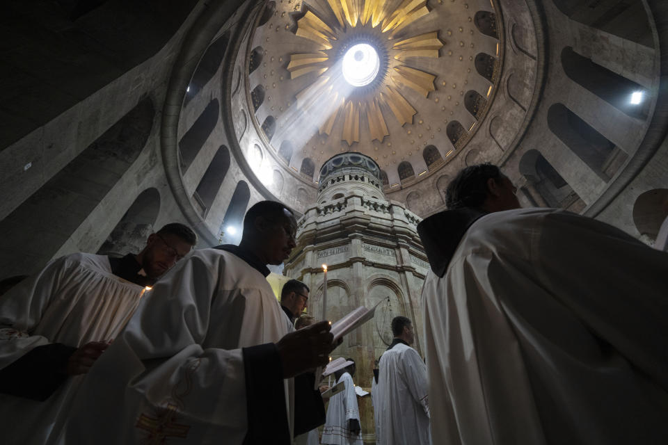 Clergymen walk in a precession around the Edicule during Easter Sunday Mass led by the Latin Patriarch at the Church of the Holy Sepulchre, where many Christians believe Jesus was crucified, buried and rose from the dead, in the Old City of Jerusalem, Sunday, March 31, 2024. (AP Photo/Leo Correa)