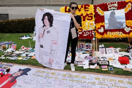 A fan from China arrives at Forest Lawn Cemetery ten years after the death of child star turned King of Pop, Michael Jackson, in Glendale, California