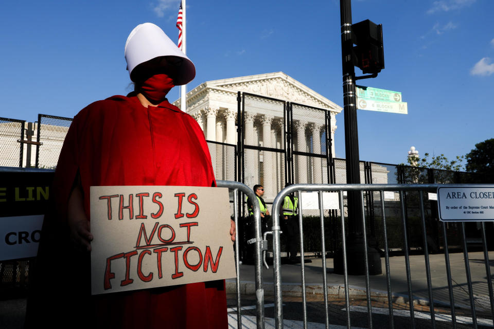 An abortion-rights demonstrator dressed as a Handmaid from Margaret Atwood's 