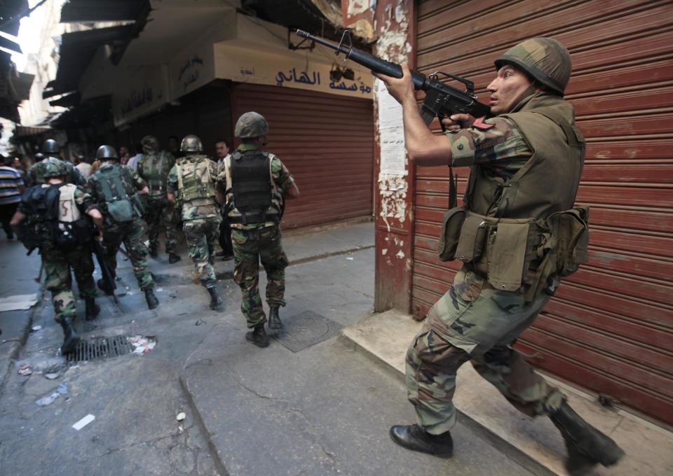 FILE -- In this May 15, 2012, file photo, Lebanese army soldiers patrol after clashes in the old market of the northern port city of Tripoli, Lebanon. From radical preachers to irreverent taxi drivers, anger is spreading through Lebanon’s Sunni community toward the country’s military, adding a dangerous twist to Lebanon’s instability, already shaken by relentless bombings. Many Sunnis accuse the military of siding with their rivals, the powerful Shiite group Hezbollah, as sectarian tensions grow in Lebanon, stoked by the civil war in neighboring Syria. (AP Photo/Hussein Malla, File)