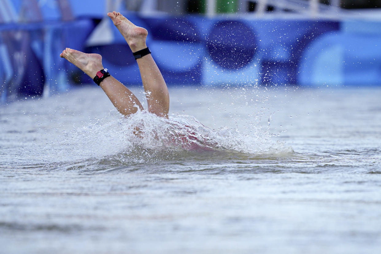 Switzerland's Julie Derron dives into the water at the start of the mixed relay triathlon at the Summer Olympics on Monday. 