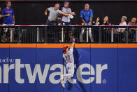 Cincinnati Reds' Jake Fraley (27) chases a ball hit by New York Mets' Francisco Lindor for a two-run home run during the third inning of a baseball game Tuesday, Aug. 9, 2022, in New York. (AP Photo/Frank Franklin II)