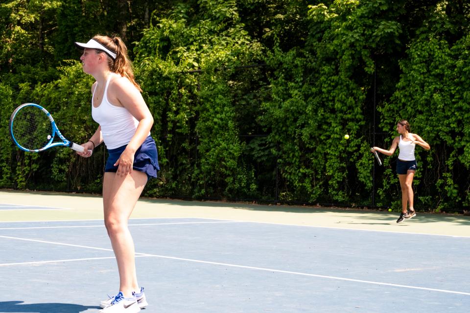 Lincoln-Sudbury's Cary Heslop (left) awaits a return, as teammate Asha Nagar serves the ball during their first doubles match against Algonquin in Sudbury, June 2, 2023.