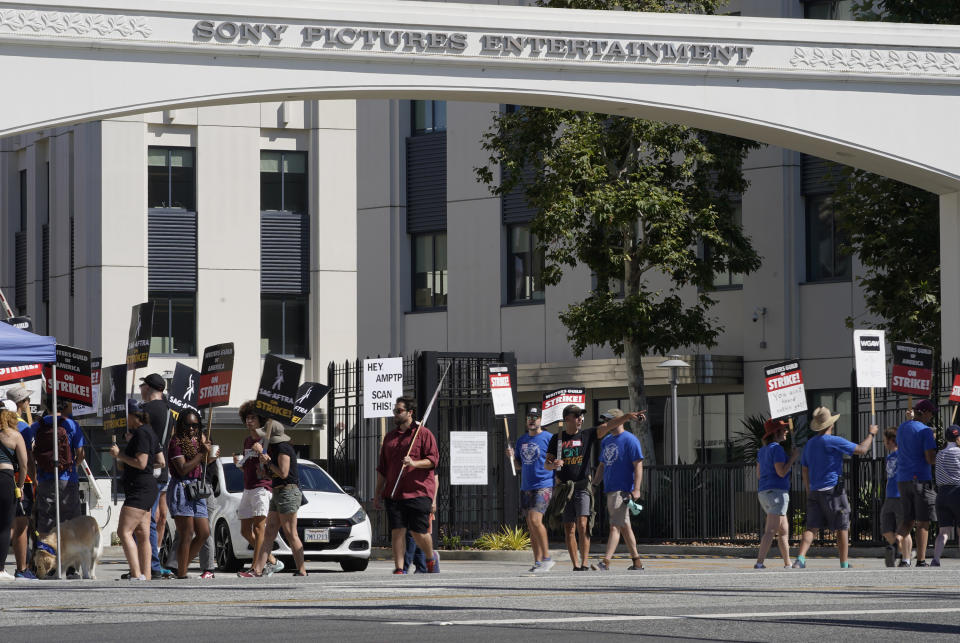 Striking writers and actors take part in a "Bastille Day: Let Them Eat Croissants" rally outside Sony Pictures studio in Culver City, Calif. on Friday, July 14, 2023. This marks the first day actors formally joined the picket lines, more than two months after screenwriters began striking in their bid to get better pay and working conditions. (AP Photo/Mark J. Terrill)
