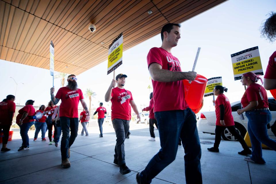 Airport workers strike outside of Terminal 3 at Sky Harbor International Airport in Phoenix on Nov. 21, 2023.