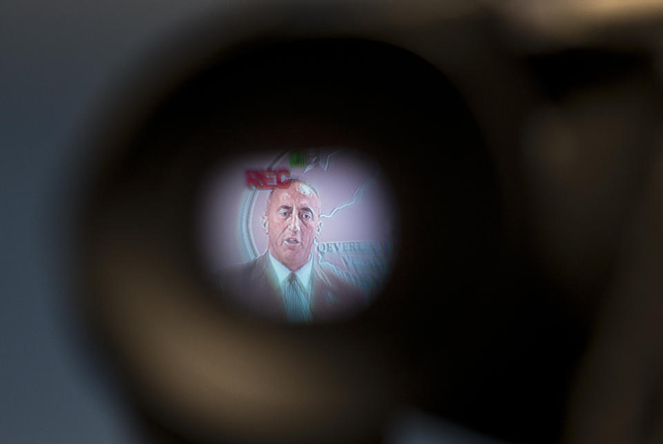 Kosovo prime minister Ramush Haradinaj, seen on a camera monitor speaks to the media in the Kosovo capital Pristina on Tuesday, Dec. 18, 2018. Haradinaj blamed Europe Union's foreign policy chief for "deviating the dialogue" on normalizing ties with Serbia. Haradinaj said that, while Serbia is taking major steps toward the integration with the bloc, his country's residents have remained "in a ghetto," not enjoying the visa-free travel to EU countries though it has fulfilled all requirements. (AP Photo/Visar Kryeziu)