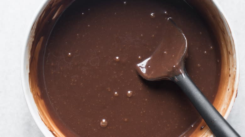 stirring fudge mixture in bowl