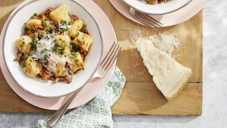 potato gnocchi with pork ragù in three bowls with forks