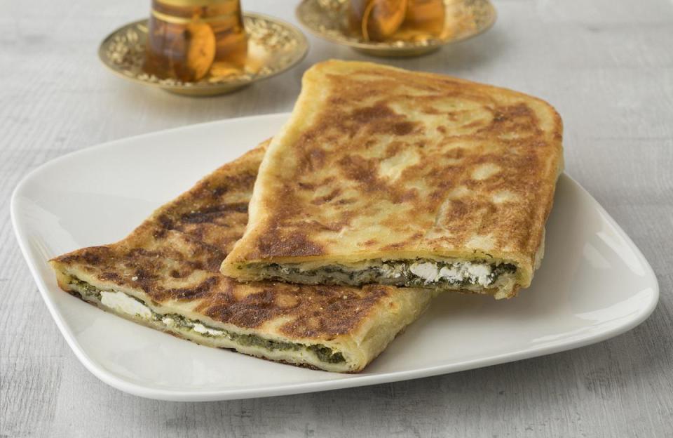 <p>Gozleme is a Turkish flatbread that’s made with yufka or Turkish pastry leaves (if you can’t find the leaves, you can use packaged filo as a substitute). The yufka is stuffed with spinach and feta cheese, which has about 21 grams of protein per cup.</p> <p><a href="https://www.thedailymeal.com/recipes/gozleme-recipe?referrer=yahoo&category=beauty_food&include_utm=1&utm_medium=referral&utm_source=yahoo&utm_campaign=feed" rel="nofollow noopener" target="_blank" data-ylk="slk:For the Gozleme recipe, click here.;elm:context_link;itc:0;sec:content-canvas" class="link ">For the Gozleme recipe, click here.</a></p>