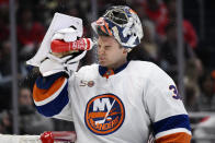 New York Islanders goaltender Ilya Sorokin (30) sprays his face during a break in the action in the second period of an NHL hockey game against the Washington Capitals, Wednesday, March 29, 2023, in Washington. (AP Photo/Nick Wass)