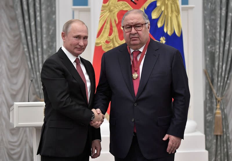 FILE PHOTO: Russian President Putin and Russian businessman Usmanov attend an awarding ceremony in Moscow