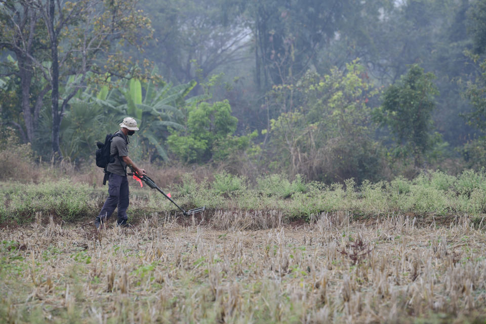 U.S. Navy Chief Petty Officer David Hanaumi, an explosive ordnance disposal technician assigned to the Defense POW/MIA Accounting Agency (DPAA), searches for metal hits at an excavation site in Lampang Province, Thailand, Feb. 16, 2022. Possible human remains were found at a crash site in a rice field in northern Thailand by the Defense POW/MIA Accounting Agency and were sent to Hawaii where they will be tested to see if they belong to a U.S. pilot who went missing in 1944. (U.S. Army Sgt. 1st Class Michael O'Neal/Defense POW/MIA Accounting Agency via AP)