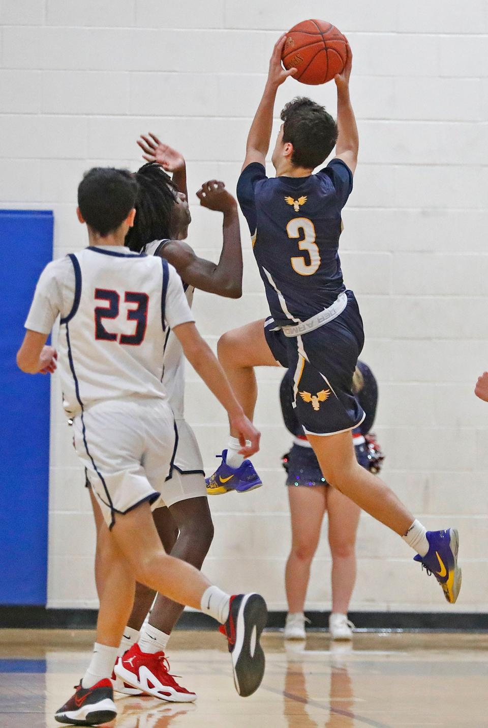 Hawk Tyler Vincent drives to the basket through Titan Gerald Ellison and Michael Marcella.
The Pembroke Titans hosted Hanover Hawks in boys basketball action Friday Jan. 19, 2024