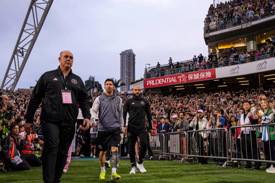 Inter Miami's Lionel Messi is escorted as he arrives at a training for a friendly football match between Hong Kong Team and US Inter Miami CF at the Hong Kong Stadium in Hong Kong, Saturday, Feb. 3, 2024.