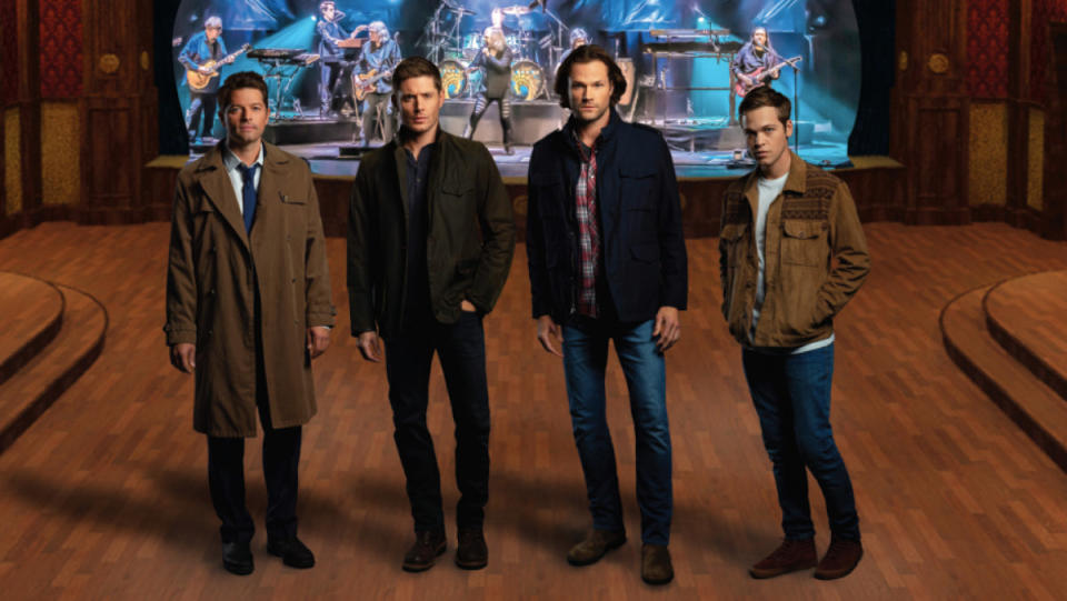 Four men stand in front of stage in the Supernatural crew book