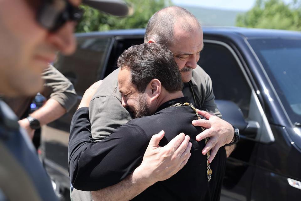 In this photo released by The Telegram Channel of the administration of the head of Dagestan Republic of Russia on Monday, June 24, 2024, the head of Dagestan Republic Sergei Melikov, center, embraces and comforts a priest as he visits the Orthodox Church of the Intercession of the Blessed Virgin Mary in Derbent after a counter-terrorist operation in republic of Dagestan, Russia. Multiple police officers and several civilians, including an Orthodox priest, were killed by armed militants in Russia's southern republic of Dagestan on Sunday, its governor Sergei Melikov said in a video statement early Monday. (The Telegram Channel of the administration of the head of Dagestan Republic of Russia via AP)