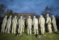 FILE In this file photo taken on Wednesday, April 29, 2020, Servicemen of Belarus Ministry of Defence wearing protective gear prepare to disinfect a local hospital in the town of Zaslavl, outside the capital Minsk, Belarus. The 9.5-million Belarus has reported more than 68,500 infections, including 580 deaths. Critics have accused the authorities of manipulating statistics to hide the real number of deaths. (AP Photo/Sergei Grits, File)