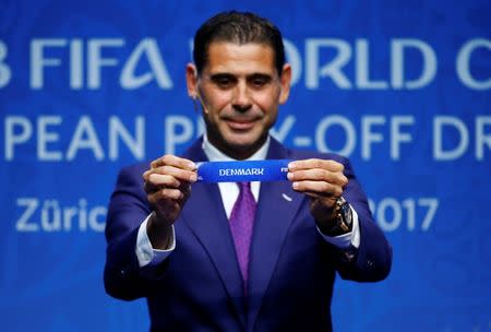 Soccer Football - FIFA World Cup European Play-Off Draw - Zurich, Switzerland - October 17, 2017. Former Spanish player Fernando Hierro displays the name 'Denmark' during the draw. REUTERS/Arnd Wiegmann