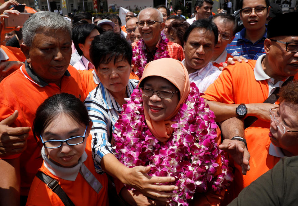 Singapore's President-elect Halimah Yacob greets supporters as she leaves the nomination centre in Singapore September 13, 2017. REUTERS/Edgar Su