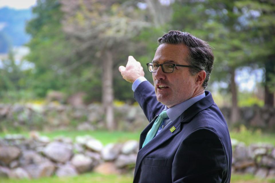 Trustees of Reservations President and CEO John Judge points toward the East Branch of the Westport River as he speaks about the Trustees' State of the Coast report at Westport Town Farm on Sept. 19.