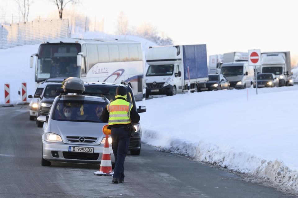 Cars and trucks from the Czech Republic stand one behind the other at a rest area on highway 17 during border controls by the German Federal Police in Bad Gottleuba, Germany, Sunday, Feb. 14, 2021. Germany has implemented tighter border controls on its frontiers with the Czech Republic and Austria’s Tyrol province in an effort to stem the spread of more contagious coronavirus variants. (Sebastian Kahnert/dpa via AP)