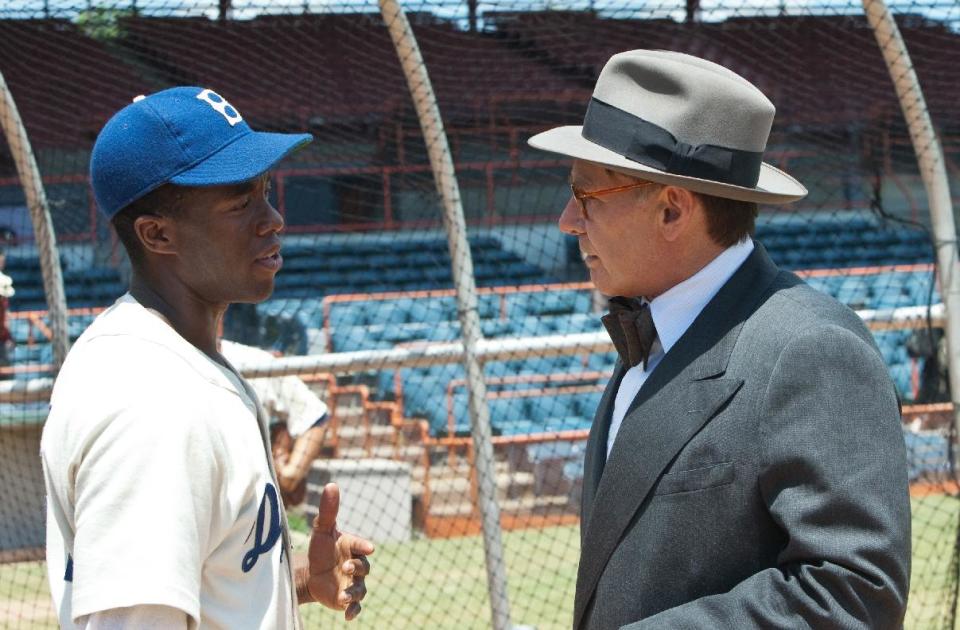 This film image released by Warner Bros. Pictures shows Chadwick Boseman as Jackie Robinson, left, and Harrison Ford as Branch Rickey in a scene from "42." (AP Photo/Warner Bros. Pictures, D. Stevens)