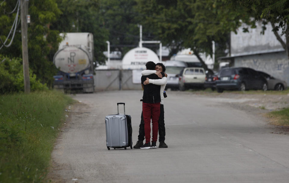 A man who was deported from the United States, foreground, is welcomed by a relative outside the Ramon Villeda International Airport in La Lima, Honduras on Nov. 29, 2019. While immigration advocates acknowledge some cases don't meet the legal standard for asylum, they believe the real intention of the ever-tighter White House policies are to discourage migrants - even those with valid needs for asylum - from trying to reach the U.S. (AP Photo/Moises Castillo)