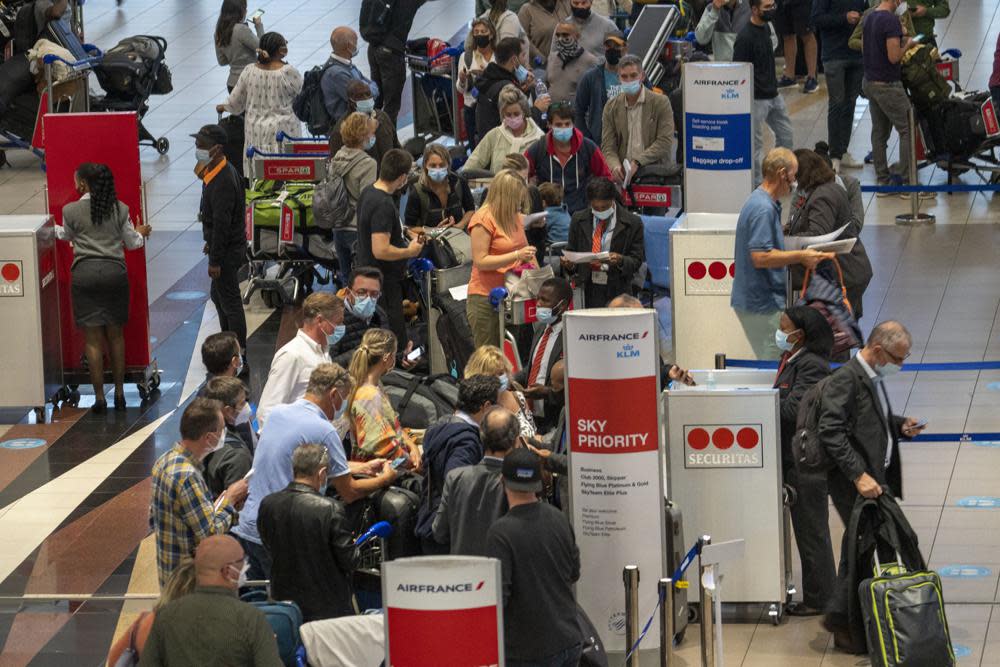 People queue to get on the Air France flight to Paris at OR Tambo’s airport in Johannesburg, South Africa, Nov. 26, 2021. (AP Photo/Jerome Delay, File)