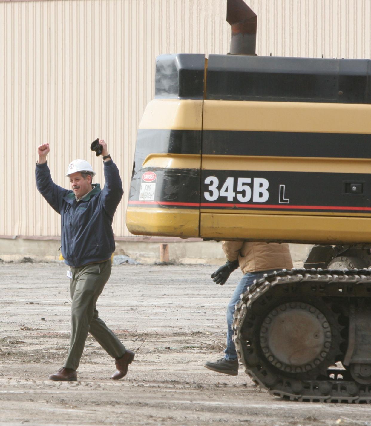 South Bend Mayor Stephen Luecke celebrates the beginning of the demolition of the former Studebaker Stamping Plant on Friday, Feb. 24, 2006. Luecke operated a large wrecking machine chipping away the first bricks off the plant, which is being razed to make way for more development, including the new Transpo headquarters.