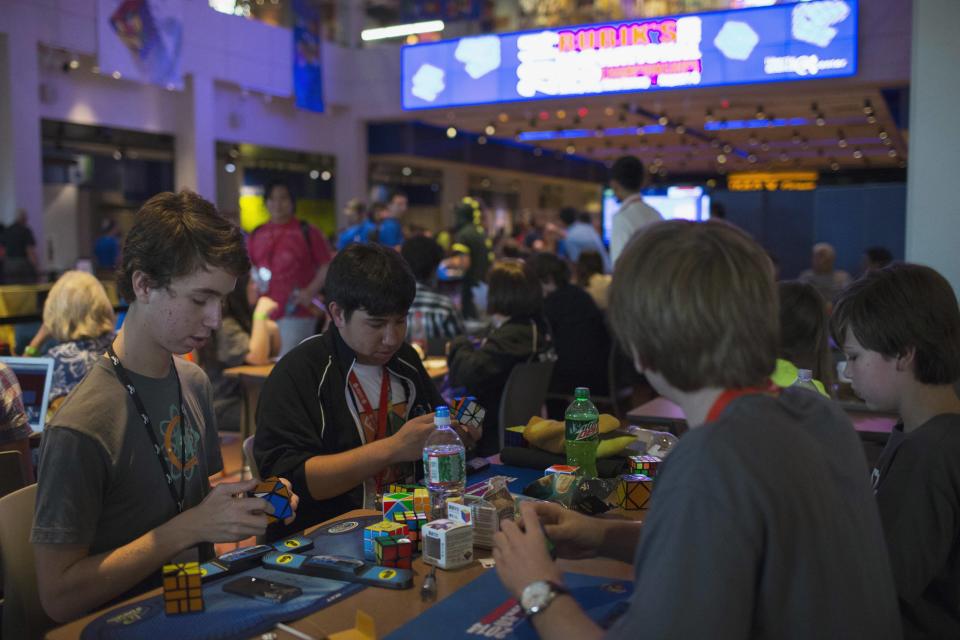 Children practice to compete at the National Rubik's Cube Championship at Liberty Science Center in Jersey City, New Jersey