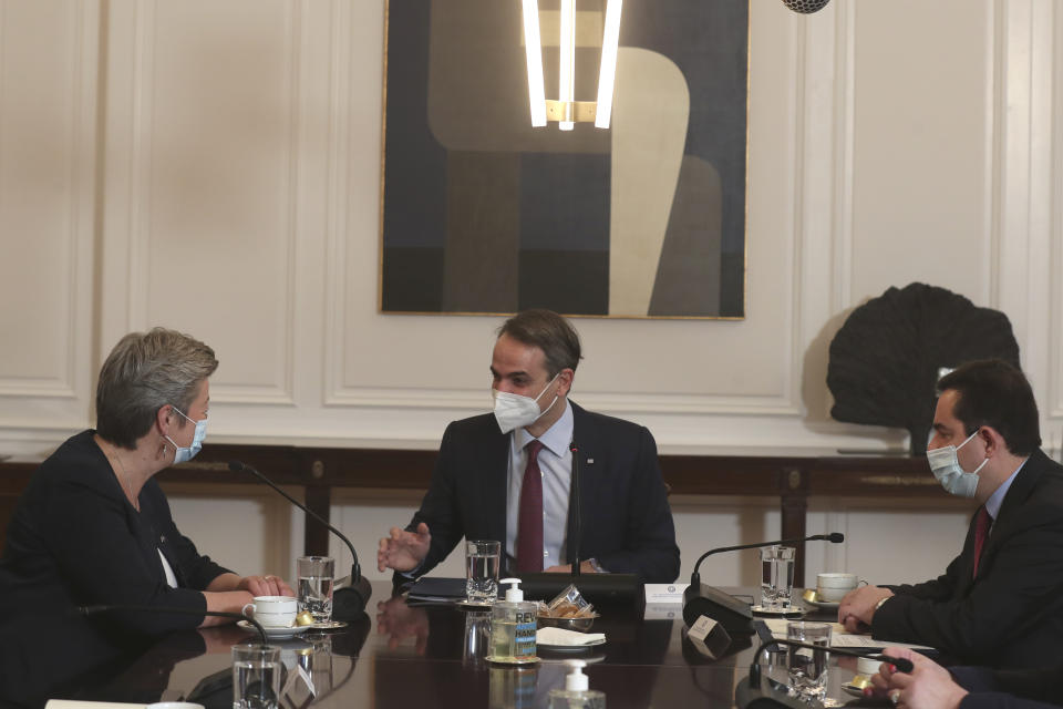 Greek Prime Minister Kyriakos Mitsotakis, centrer, speaks with European Commissioner for Home Affairs Ylva Johansson, left, as Greece's Minister of Migration and Asylum Notis Mitarachi, right, looks on, during their meeting in Athens , on Tuesday , March 30, 2021. Johansson stressed the need for solidarity among the bloc's member states in tackling migration, and called on Turkey to resume accepting the return of people whose asylum applications are rejected in Greece after arriving from Turkey. (AP Photo/Petros Giannakouris)