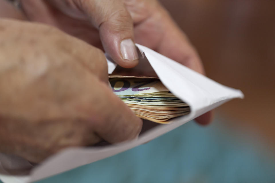 hand taking out money from an envelope