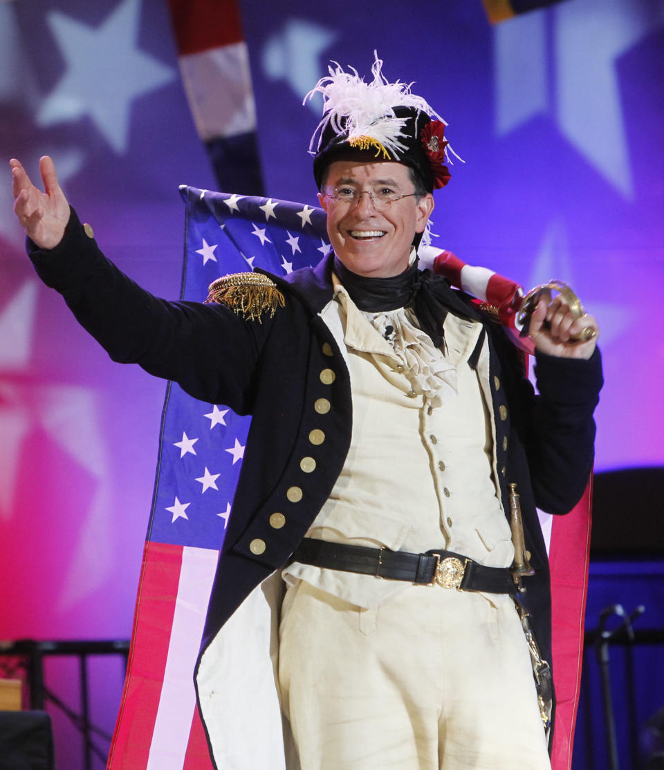 FILE - This Aug. 10, 2012 file photo shows Stephen Colbert, host of "The Colbert Report," onstage during StePhest Colbchella '012 Rocktaugustfest at the Intrepid Sea, Air & Space Museum in New York. CBS announced Thursday, April 10, 2014, Colbert will succeed David Letterman as the host of “The Late Show.” (Photo by Jason DeCrow/Invision/AP, File)