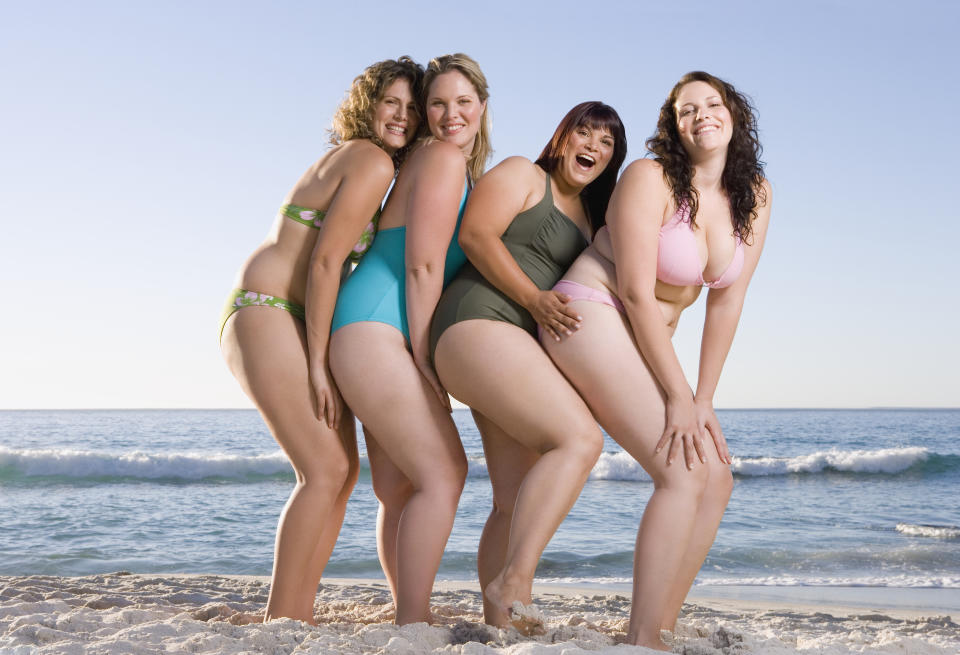 Four women on beach in swimwear