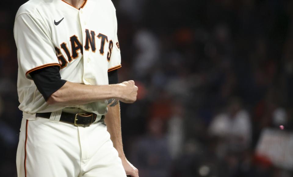 Giants starting pitcher Kevin Gausman tosses his chewing gum after retiring the side