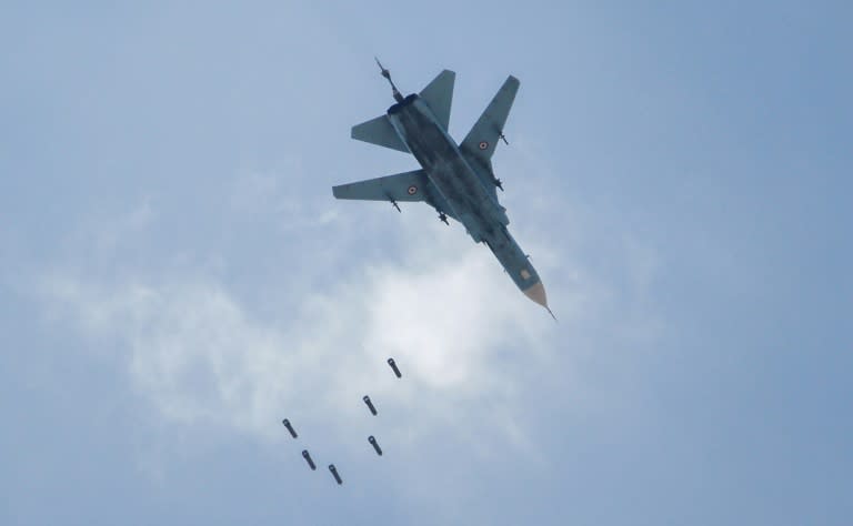 A Syrian warplane drops a payload on the rebel-held area of Qabun east of Damascus on May 6, 2017