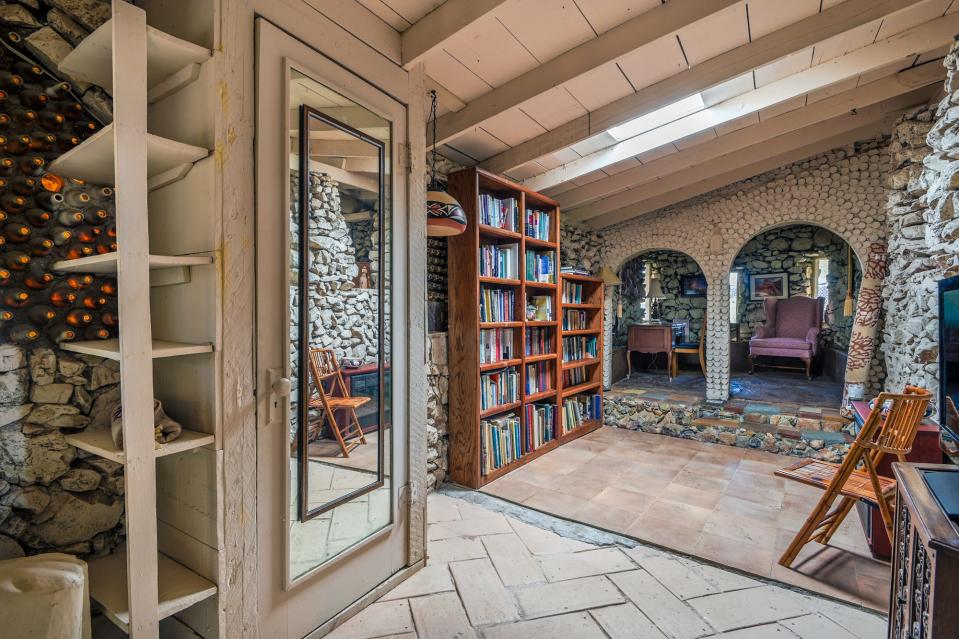 Living area in a unique home made out of recycled bottles and rocks at 1800 N Camino Altar, Tucson, Arizona, is for sale. It is listed by Holly Greenhalgh of Coldwell Banker Realty for $432,500, and was recently featured on Zillow Gone Wild.